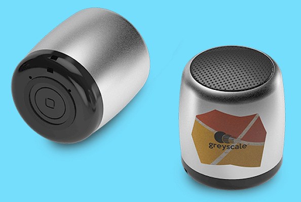 Tiny Bluetooth speakers showing the control button on the base