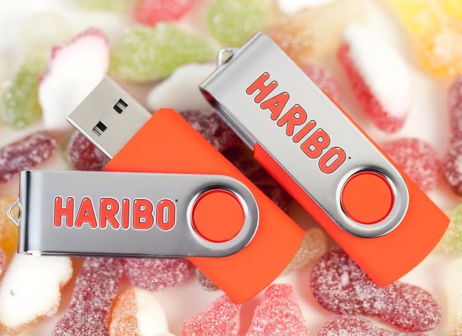 Orange branded twister USB sticks with sweets
